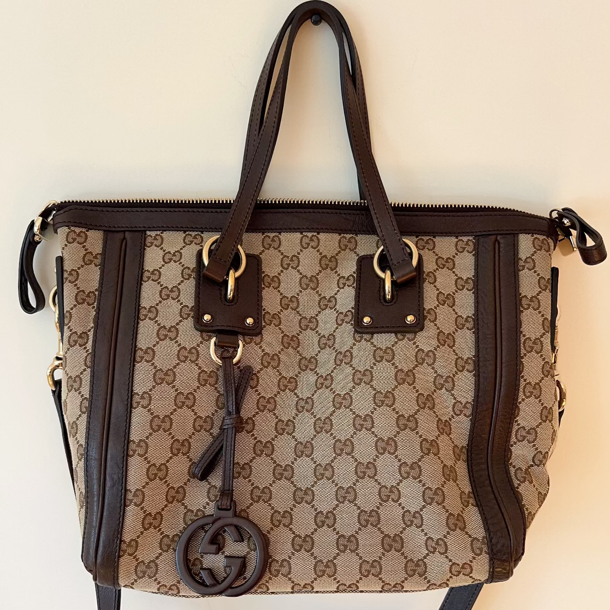Designer handbag with brand logo on a light background