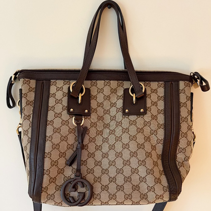 Designer handbag with brand logo on a light background