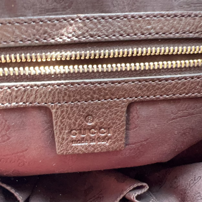 Close-up of a Gucci leather bag with visible branding.