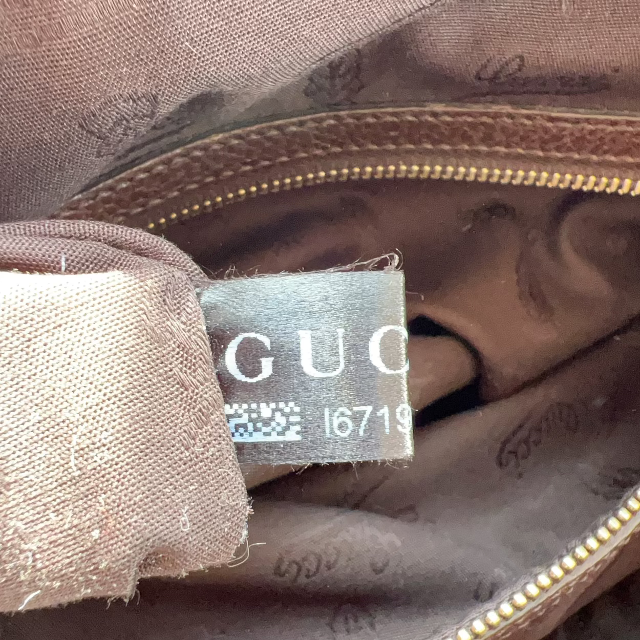 Gucci label on a brown fabric surface