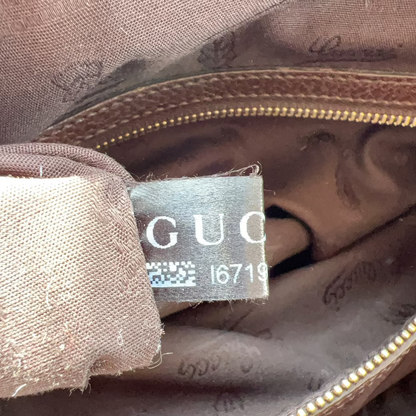 Gucci label on a brown fabric surface