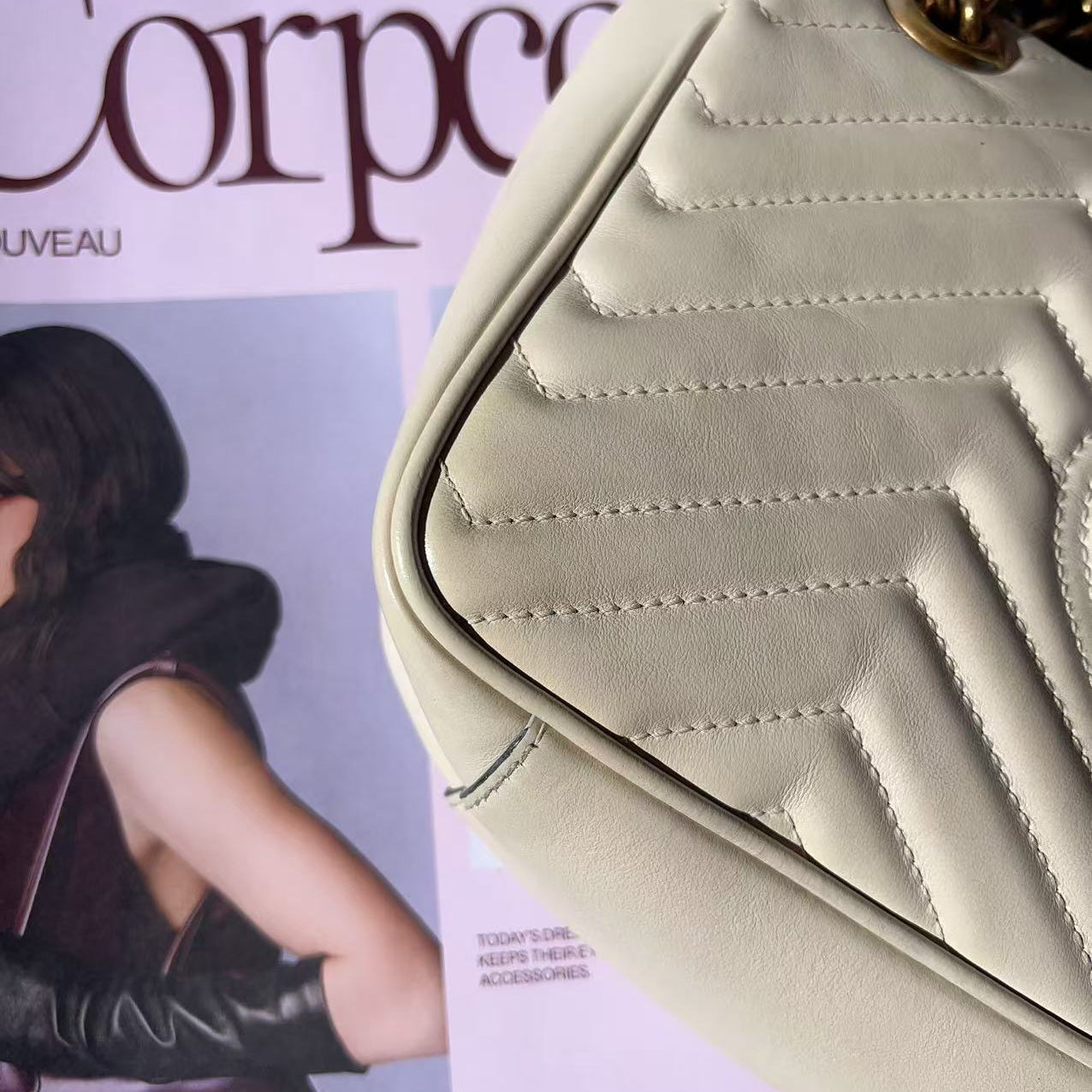 Beige handbag on a magazine with a visible brand name