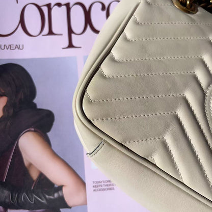 Beige handbag on a magazine with a visible brand name