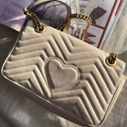 Beige handbag with heart design and gold chain