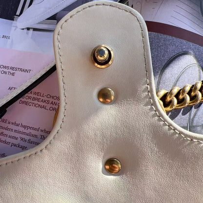 Close-up of a beige handbag with gold hardware