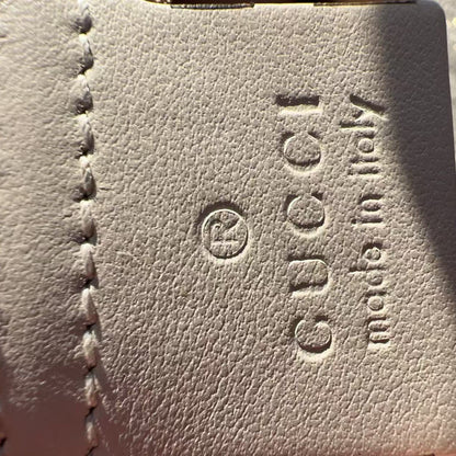 Close-up of Gucci logo and text on a leather surface