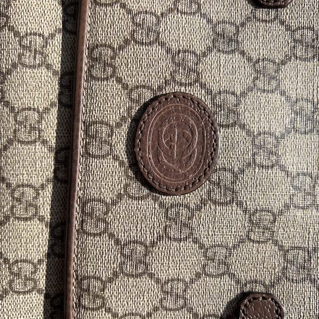 Close-up of a textured surface with a pattern and a central emblem.