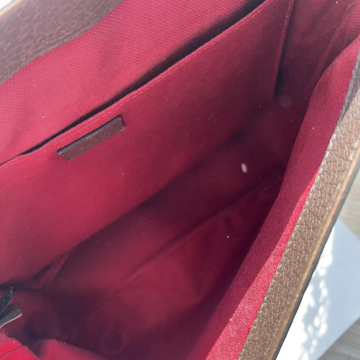 Close-up of a red fabric interior with brown trim