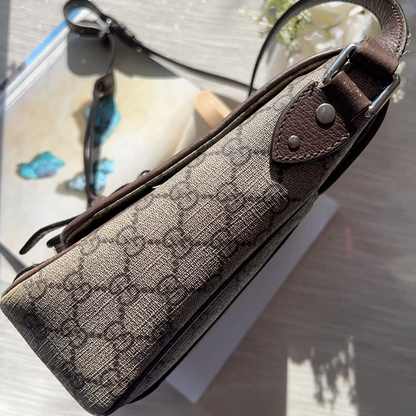 Brown fabric bag with leather strap on a light background