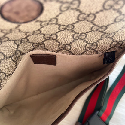 Close-up of a Gucci handbag with a visible logo and strap.