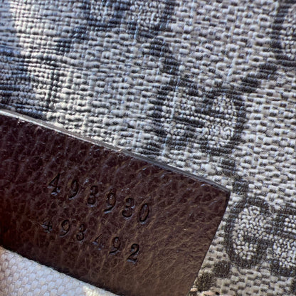 Brown leather tag with numbers on a textured fabric background