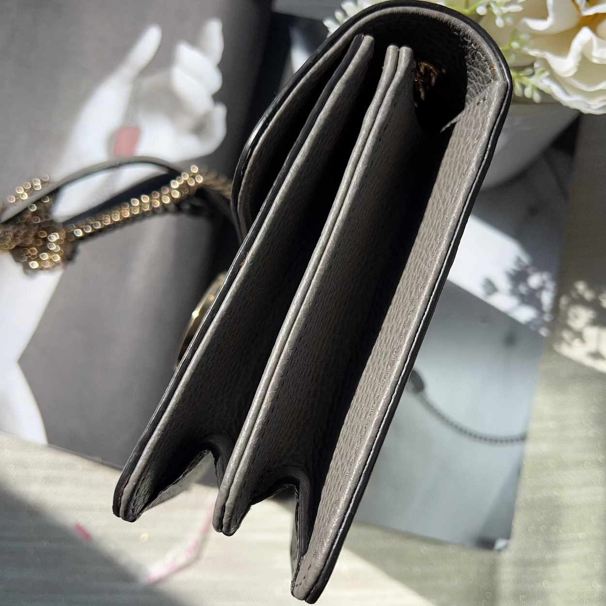 Black wallet with gold accents on a blurred background