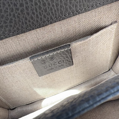 Close-up of a Gucci handbag with visible brand logo.