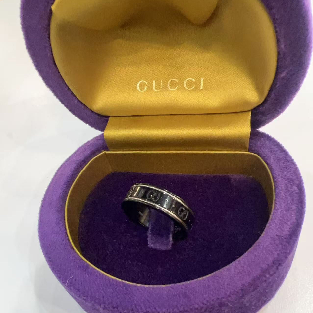 Silver ring in a Gucci purple and gold jewelry box 