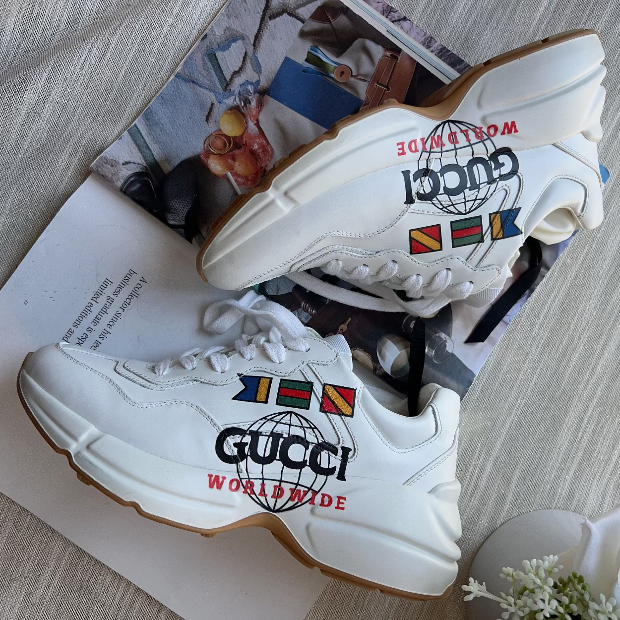 White sneakers with colorful logos on a magazine