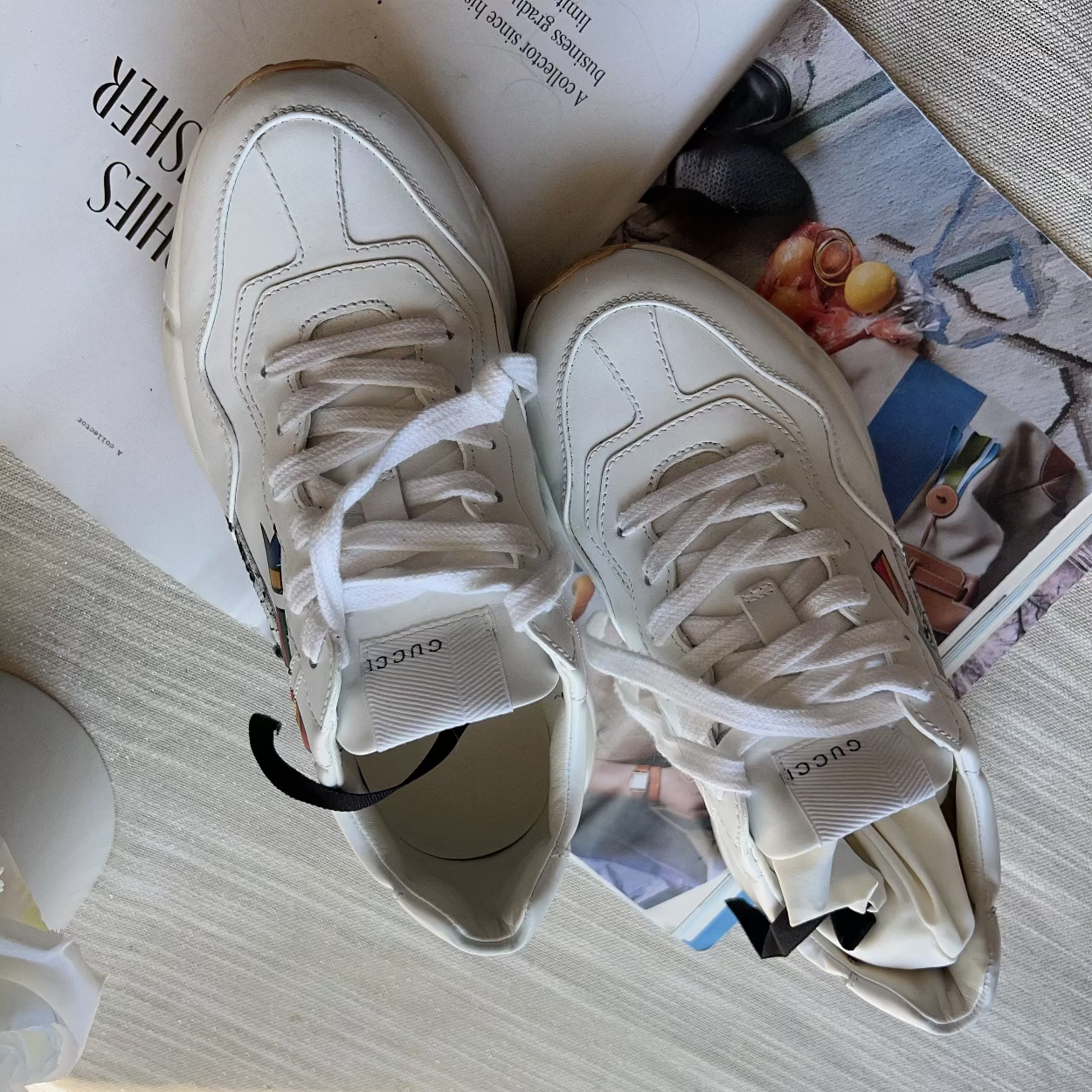 White sneakers on a magazine with a blurred background