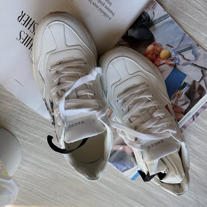 White sneakers on a magazine with a blurred background