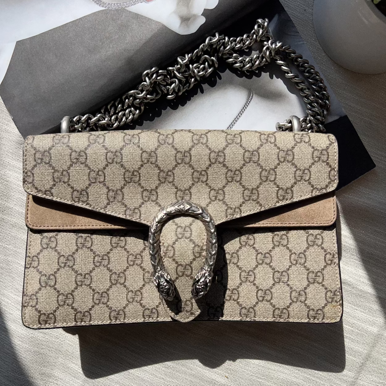 Designer handbag with chain strap on a light surface