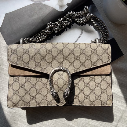 Designer handbag with chain strap on a light surface