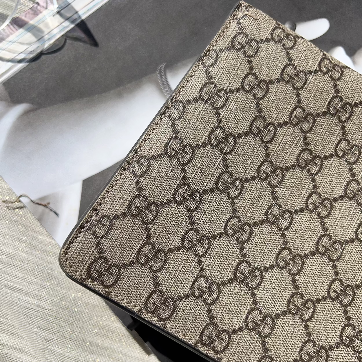 Close-up of a Gucci patterned product on a textured surface