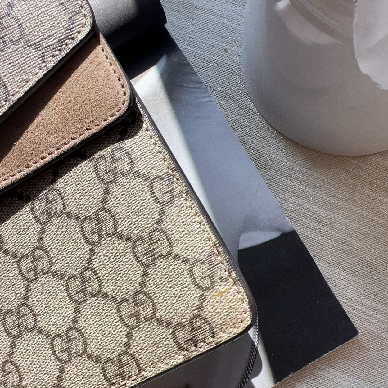 Close-up of a Gucci-patterned product on a textured surface