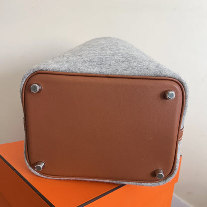 Small brown box with gray top on an orange surface