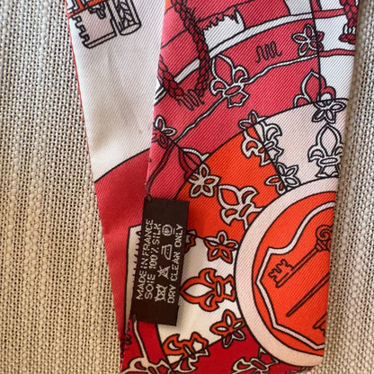 Red and white patterned fabric with a label on a beige background