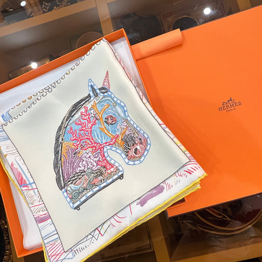 Colorful patterned pouch on a Hermès box 