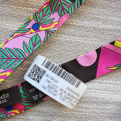 Colorful strap with a label and QR code on a textured fabric background