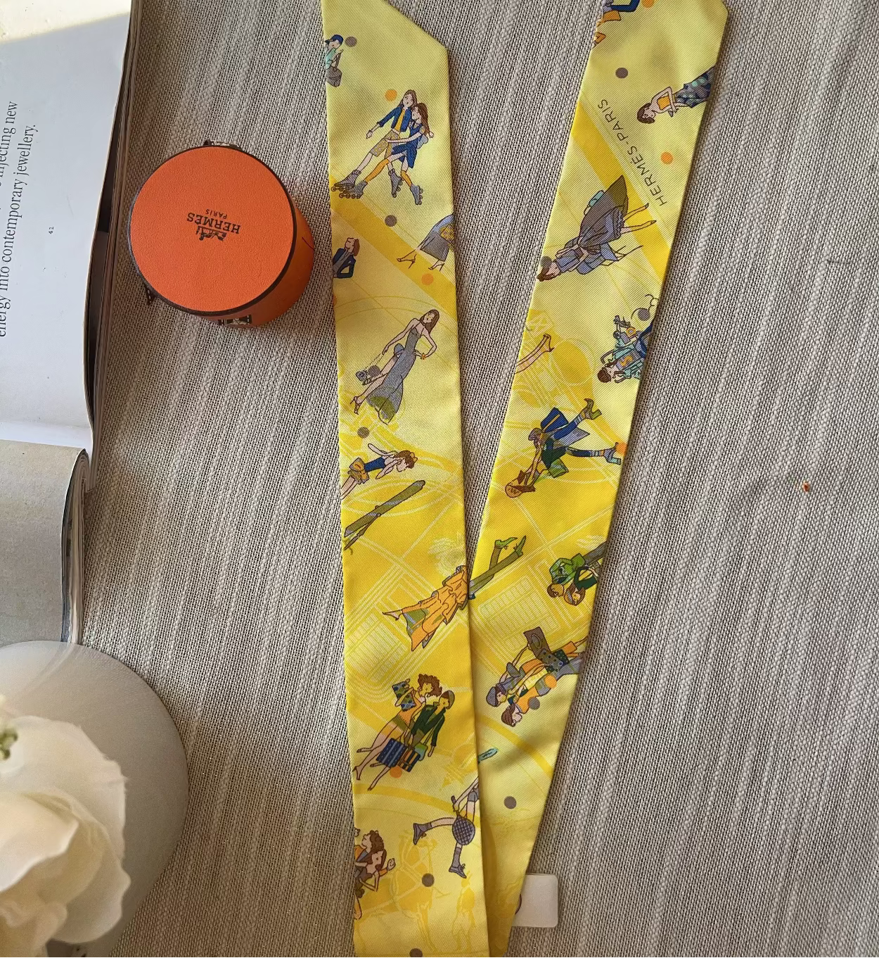 Yellow necktie with cartoon characters on a wooden surface