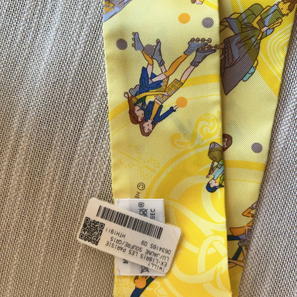 Colorful tie with cartoon characters on a textured fabric background