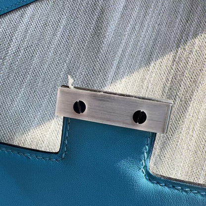 Close-up of a metal bracket on a blue fabric surface