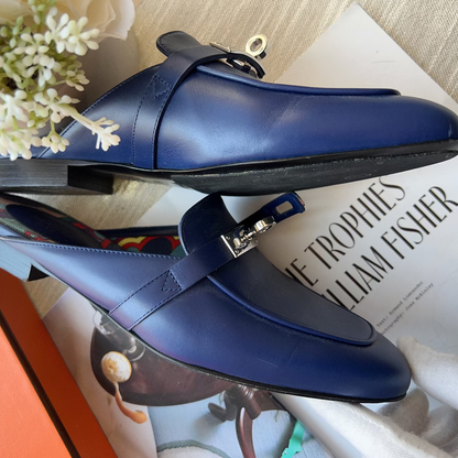 Blue loafers on a magazine with flowers in the background