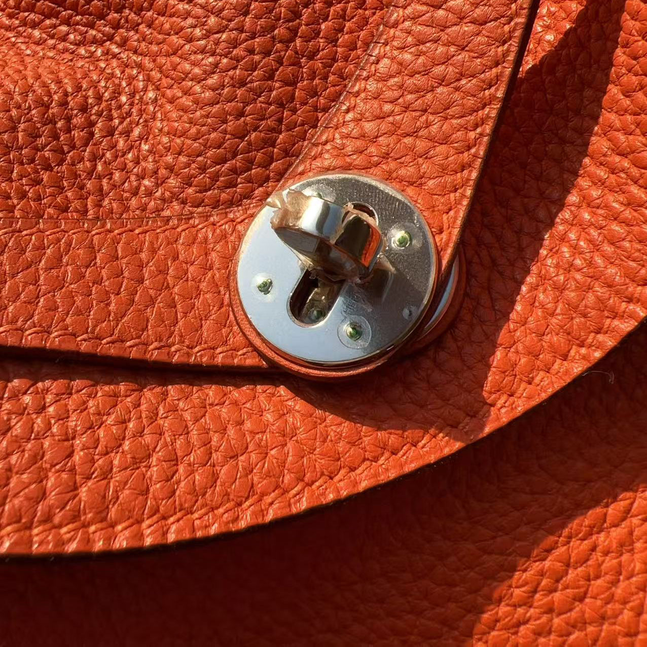 Close-up of a brown leather bag with a metal clasp