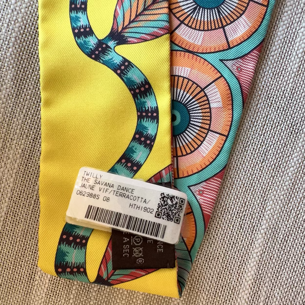 Colorful patterned fabric with a label on a textured surface