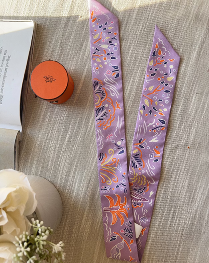 Two decorative ribbons with floral patterns on a wooden surface.