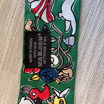 Tie with cartoon character design and brand label on a textured fabric background