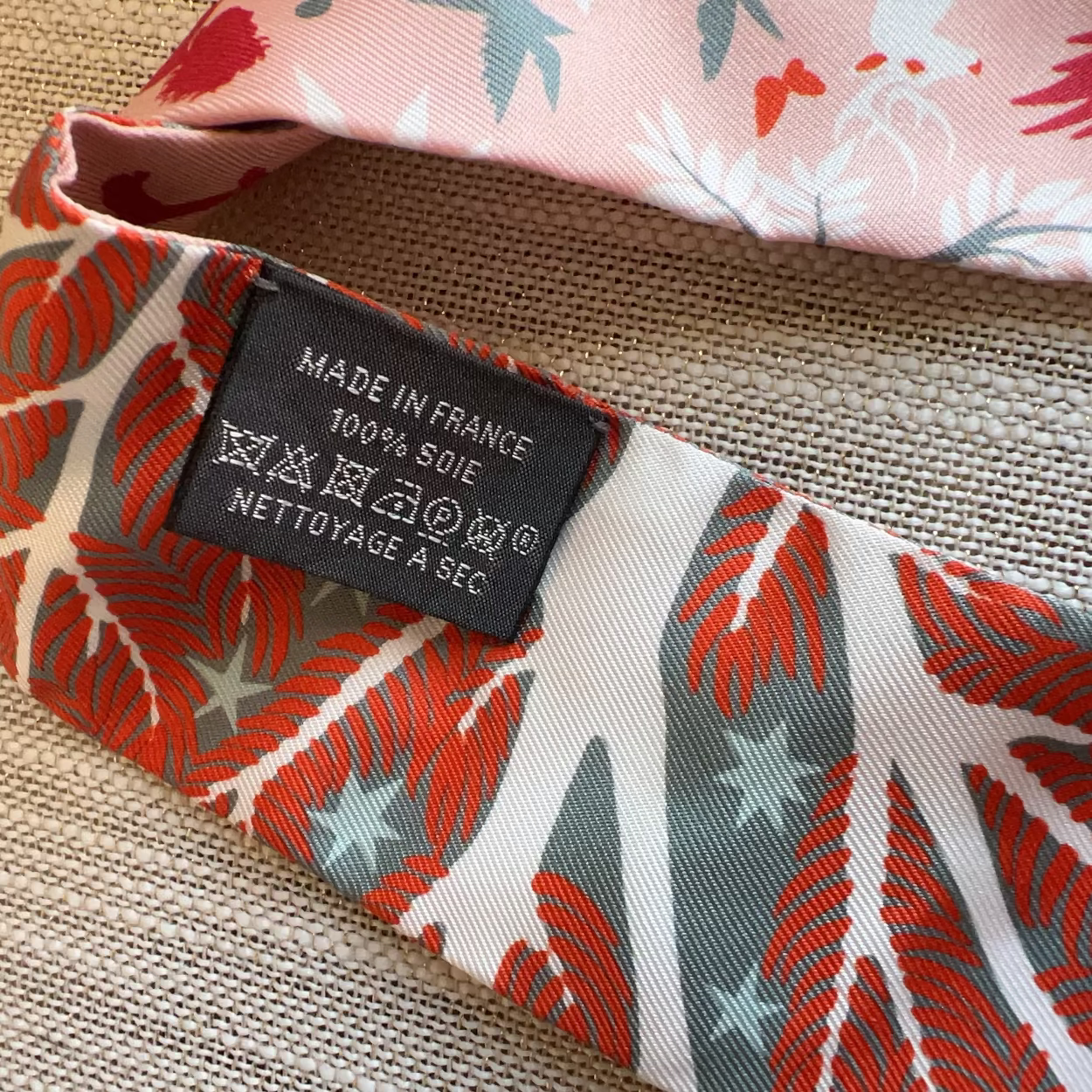 Fabric with a floral pattern and a 'Made in France' label on a textured surface
