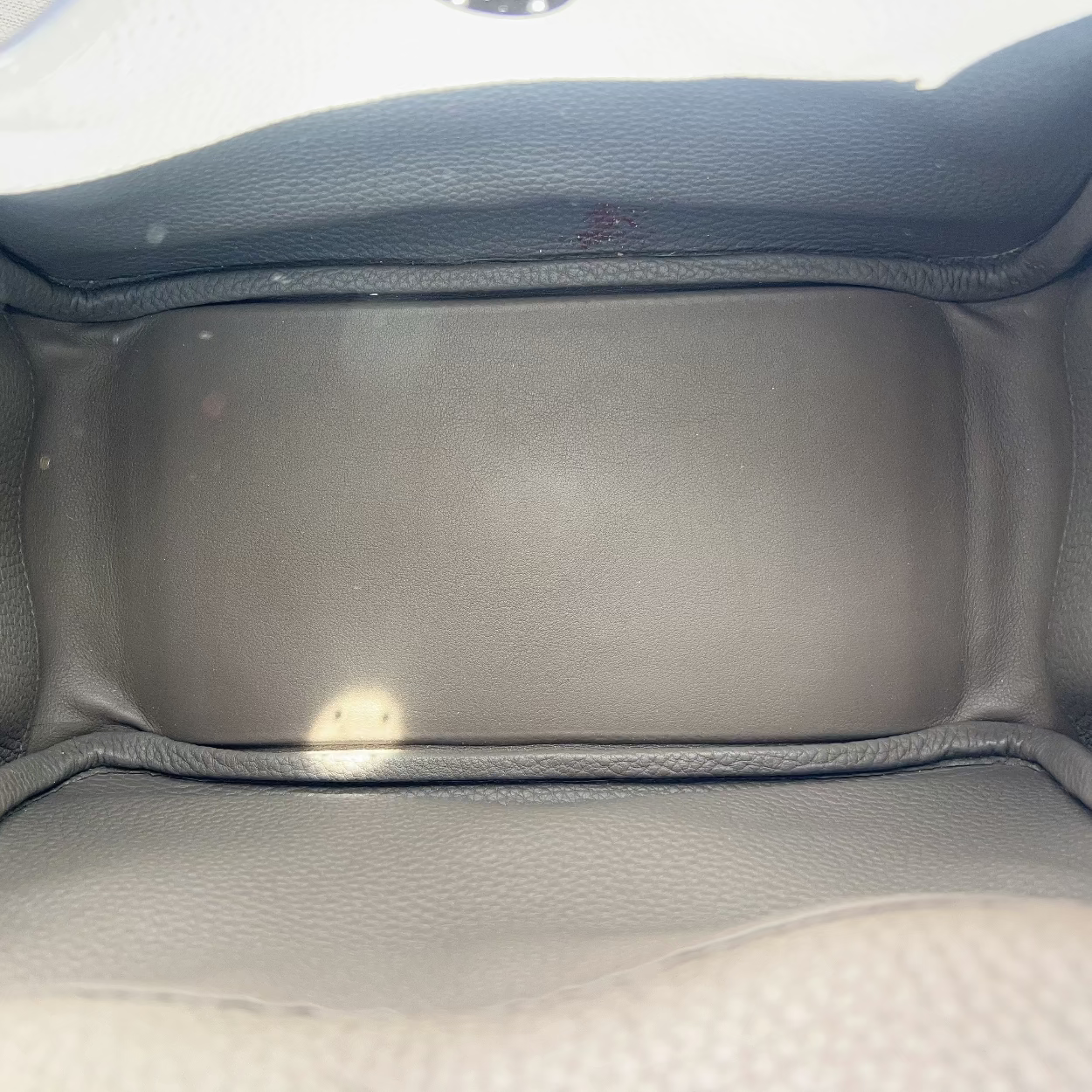 Gray car interior with a focus on the back seat area.