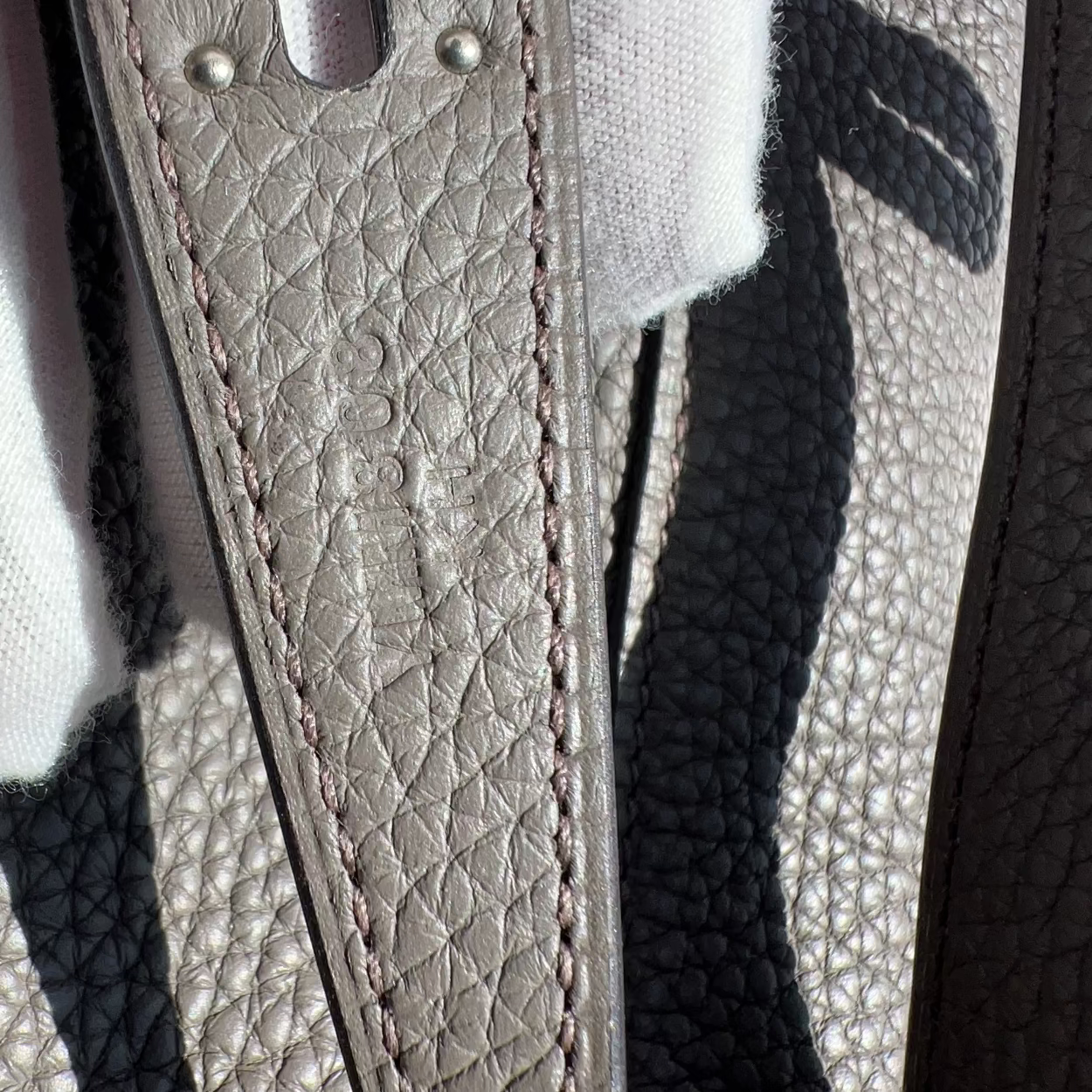 Close-up of a textured leather strap with stitching details