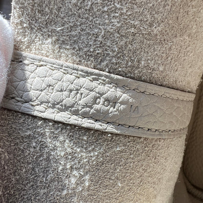 Close-up of a textured fabric surface with a brand logo.