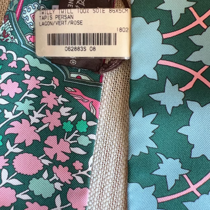Close-up of a patterned tie with a visible brand tag.