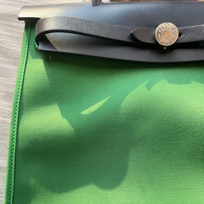 Green fabric with a visible brand logo on a neutral background