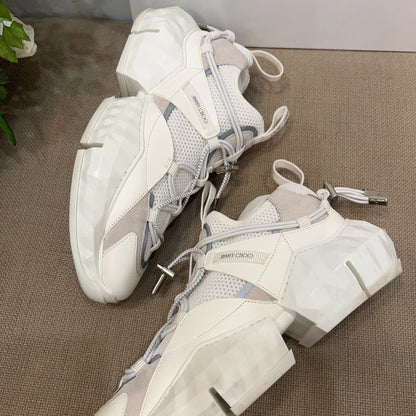 Pair of white and gray sneakers on a textured surface