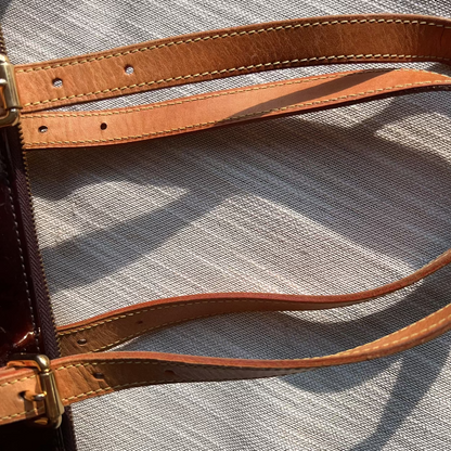 Close-up of a brown leather strap on a textured surface
