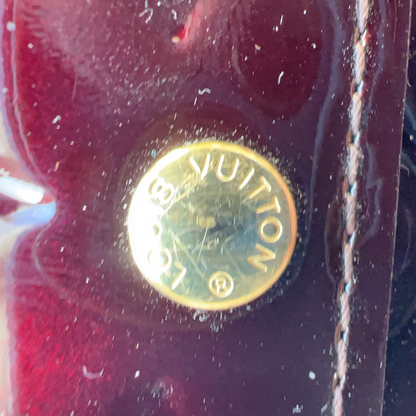 Close-up of a Louis Vuitton logo on a red background