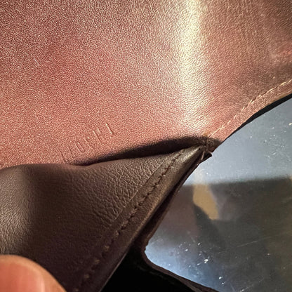 Close-up of brown leather surface with visible stitching