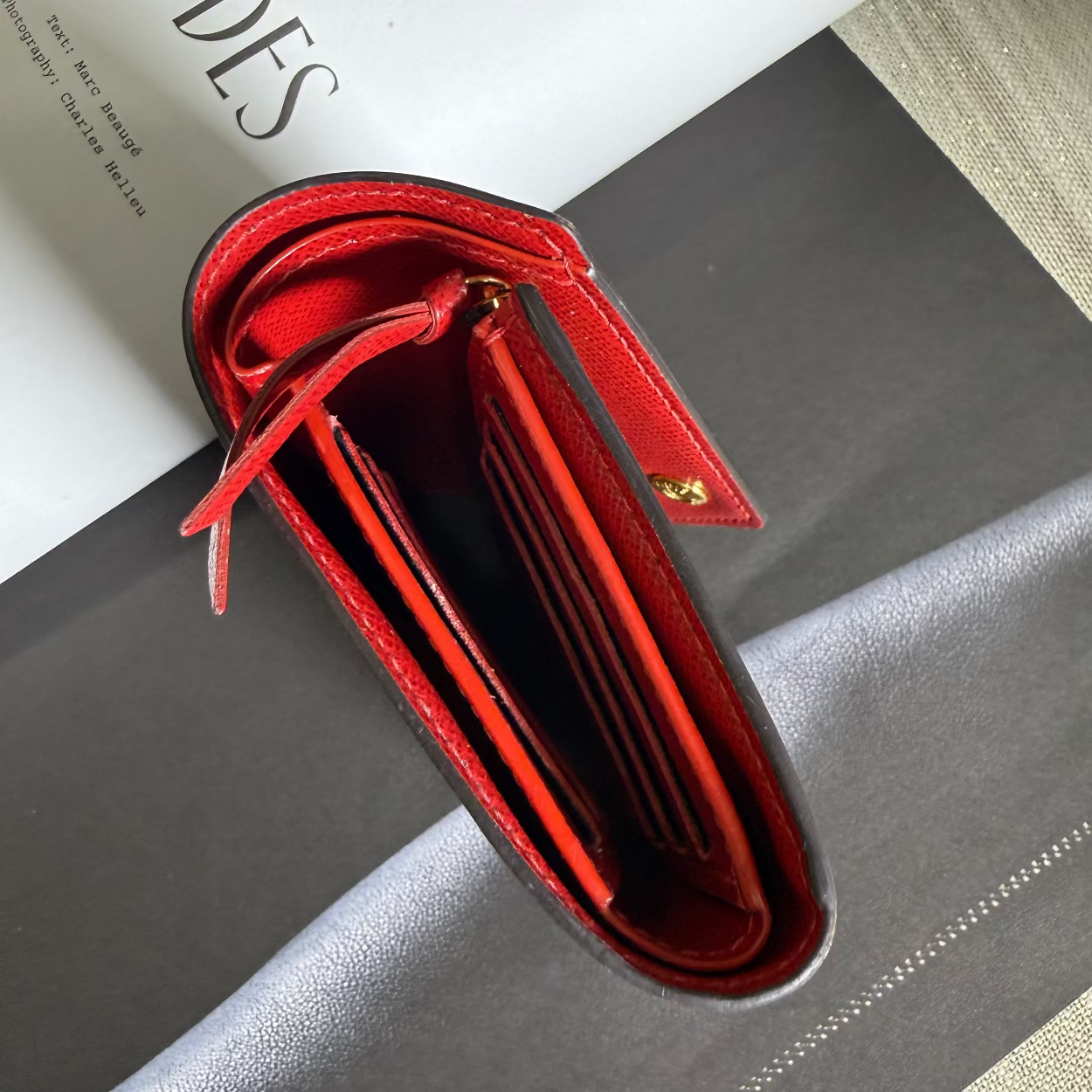 Red wallet open on a surface with 'ZIP CODES' text in the background