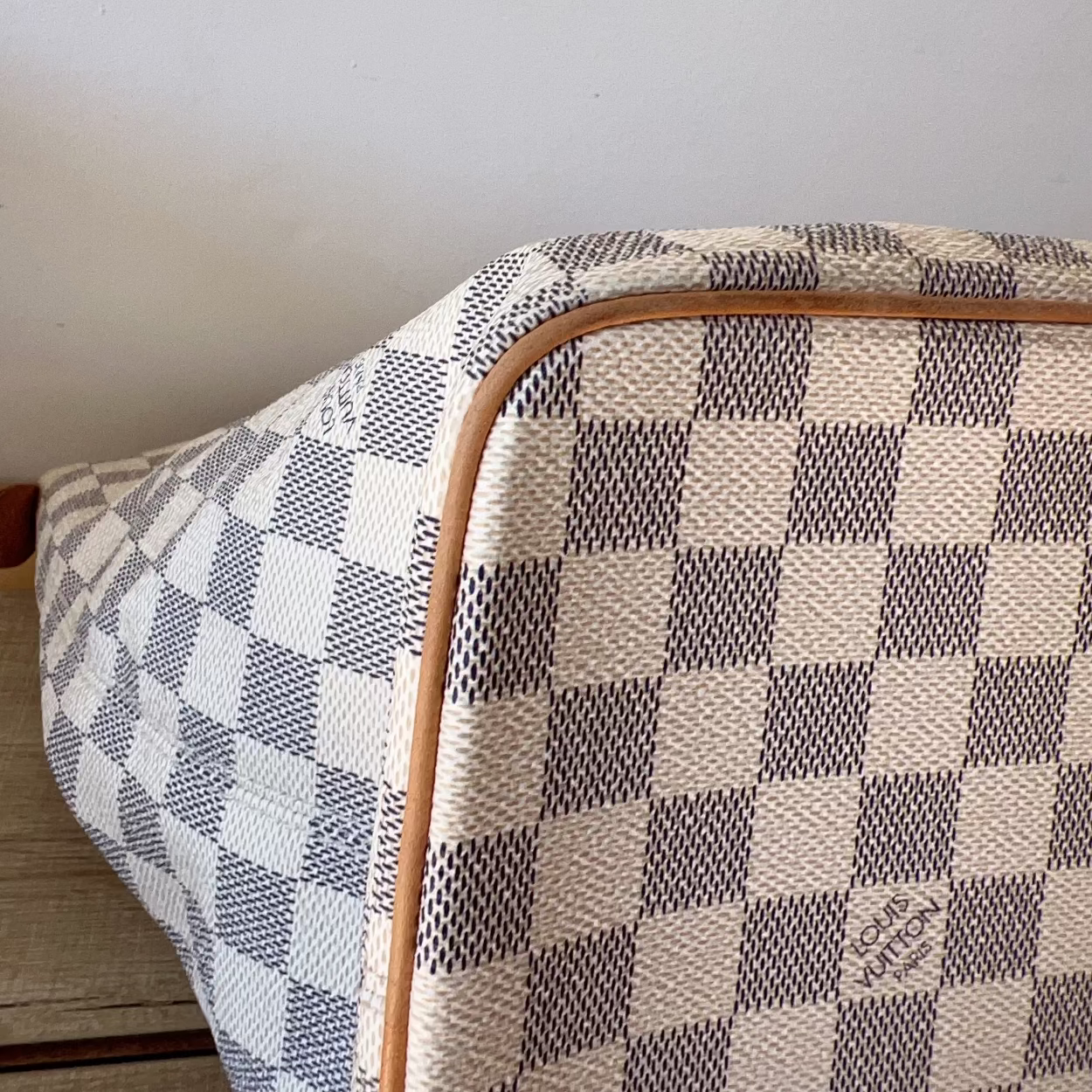 Checkered fabric with a wooden frame on a light gray background