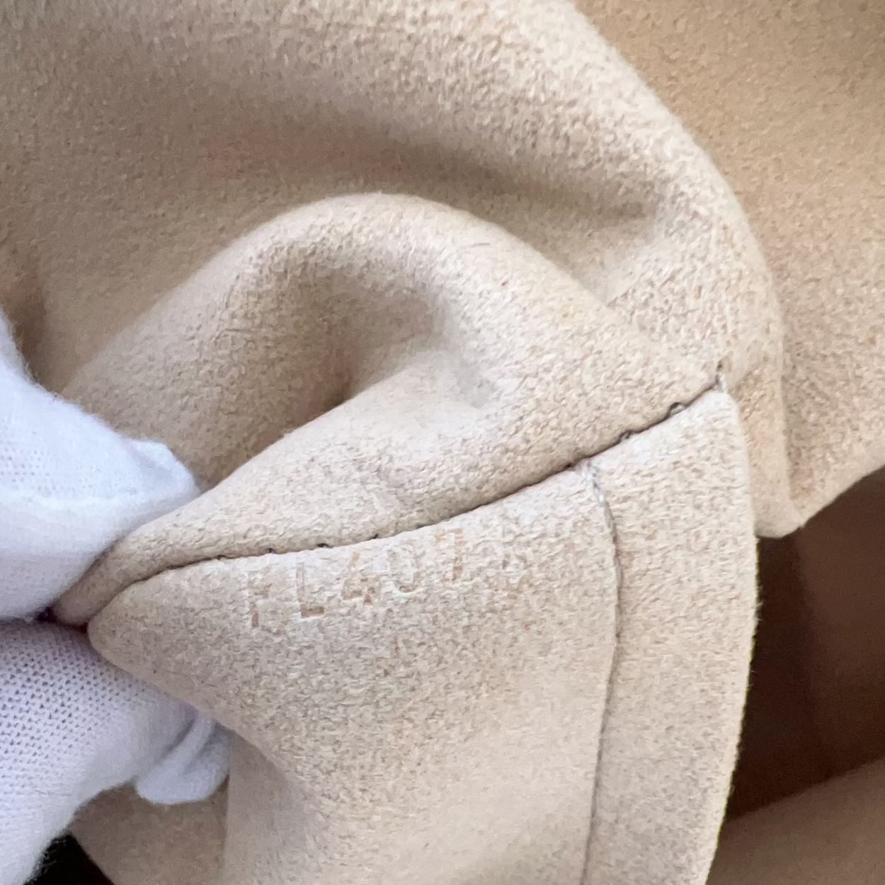 Close-up of beige fabric with a white cloth